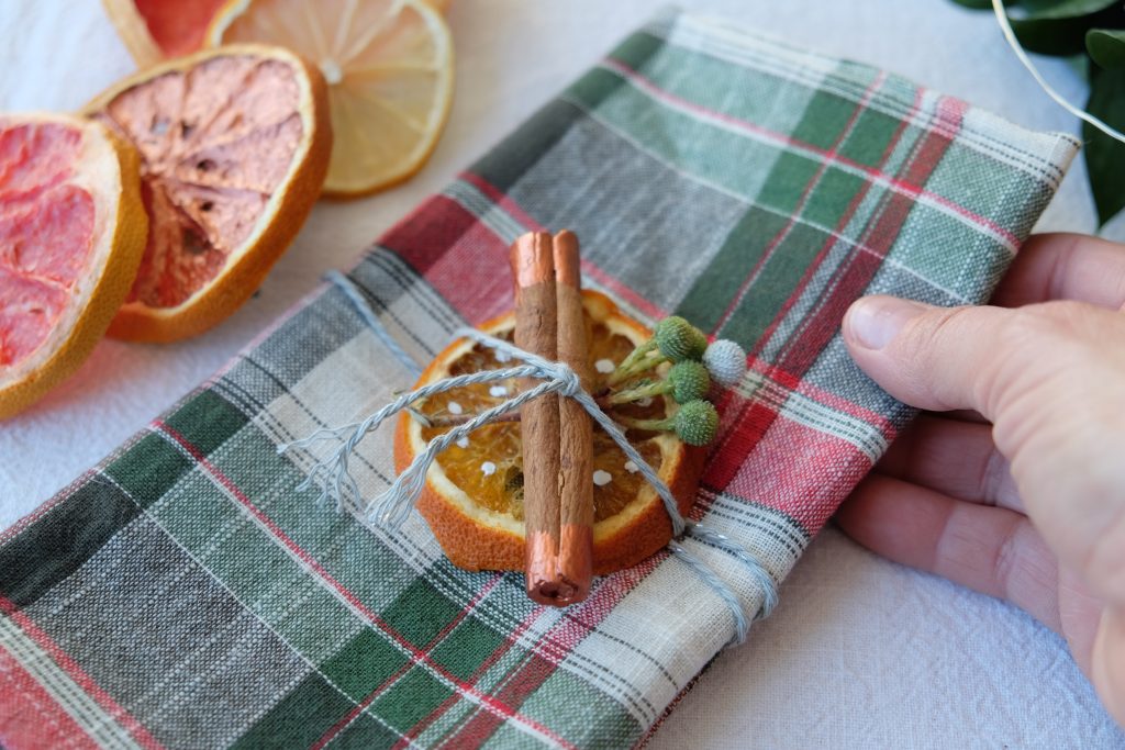 Combine your Christmas centerpiece with other decorative elements such as napkin rings